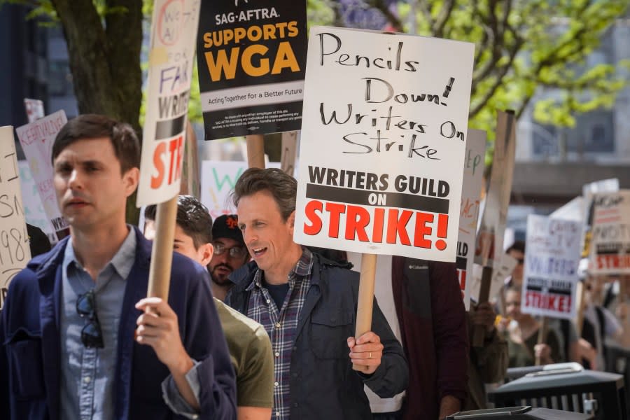 Late night talk show host Seth Meyers, right, joins striking members of the Writers Guild of America on the picket line during a rally outside Silvercup Studios, Tuesday May 9, 2023, in New York. (AP Photo/Bebeto Matthews)