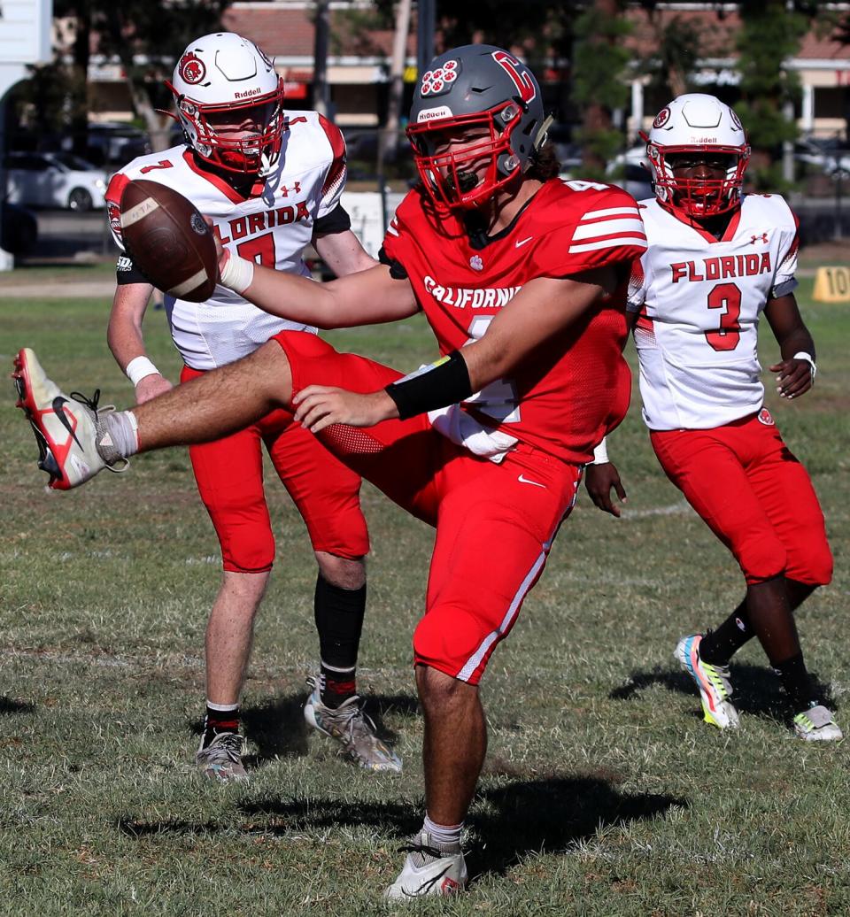 CSDR quarterback Trevin Adams celebrates after scoring a touchdown.