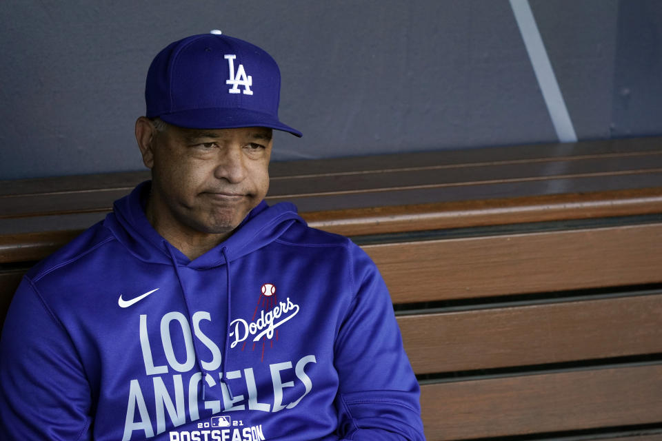 Los Angeles Dodgers manager Dave Roberts sits in the dugout during a workout ahead of Game 3 of baseball's National League Championship Series against the Atlanta Braves, Monday, Oct. 18, 2021, in Los Angeles. (AP Photo/Marcio Jose Sanchez)