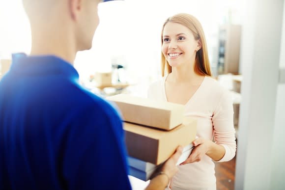 A woman receiving a package delivery.