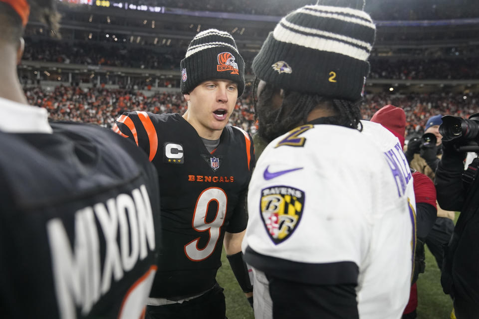 Cincinnati Bengals quarterback Joe Burrow (9) and Baltimore Ravens quarterback Tyler Huntley talk following an NFL wild-card playoff football game in Cincinnati, Sunday, Jan. 15, 2023. The Bengals won 24-17. (AP Photo/Darron Cummings)