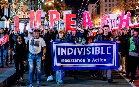 Several hundred of protesters march in San Francisco during a demonstration in part of a national impeachment rally - Credit: AFP