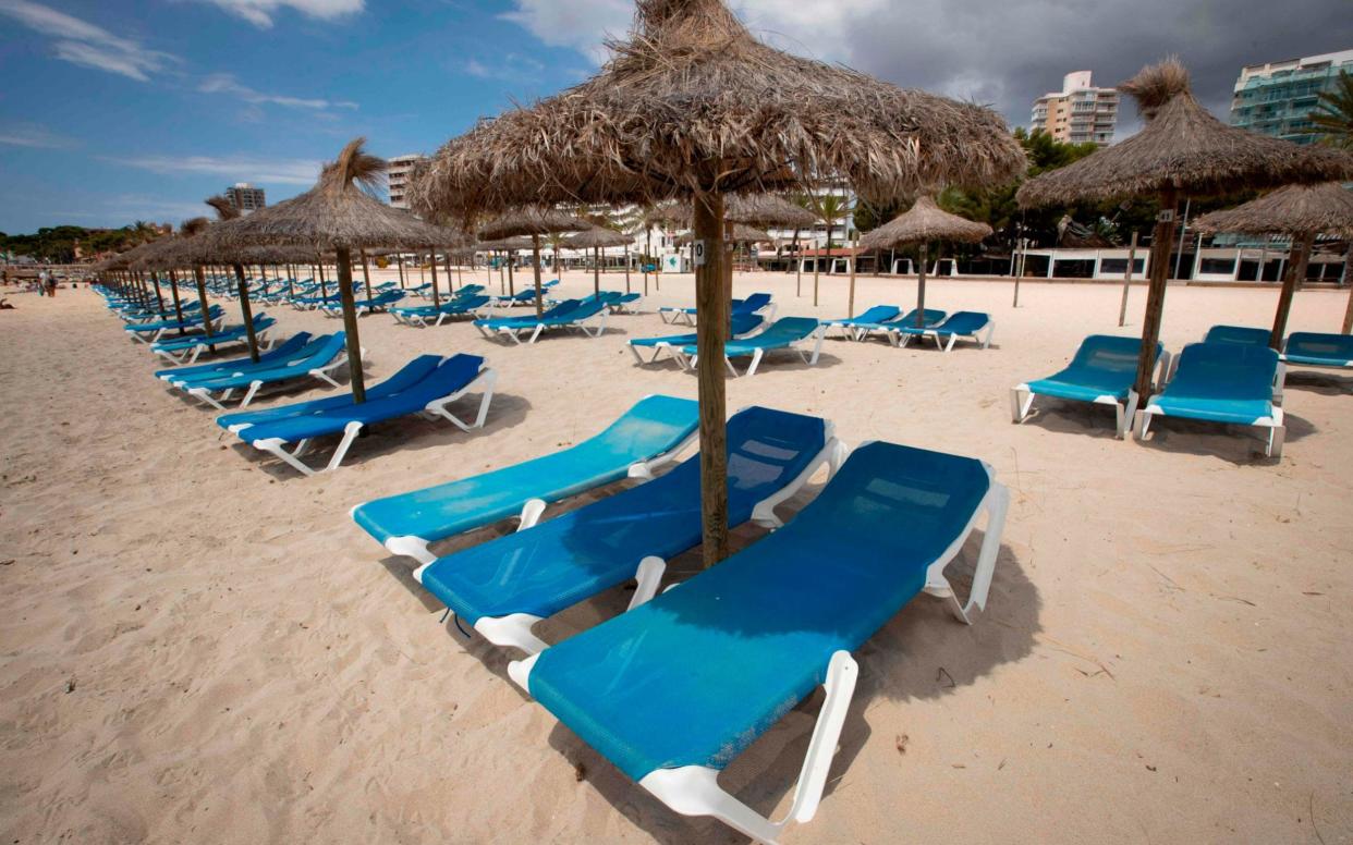 Empty deck chairs on Magaluf beach in Majorca