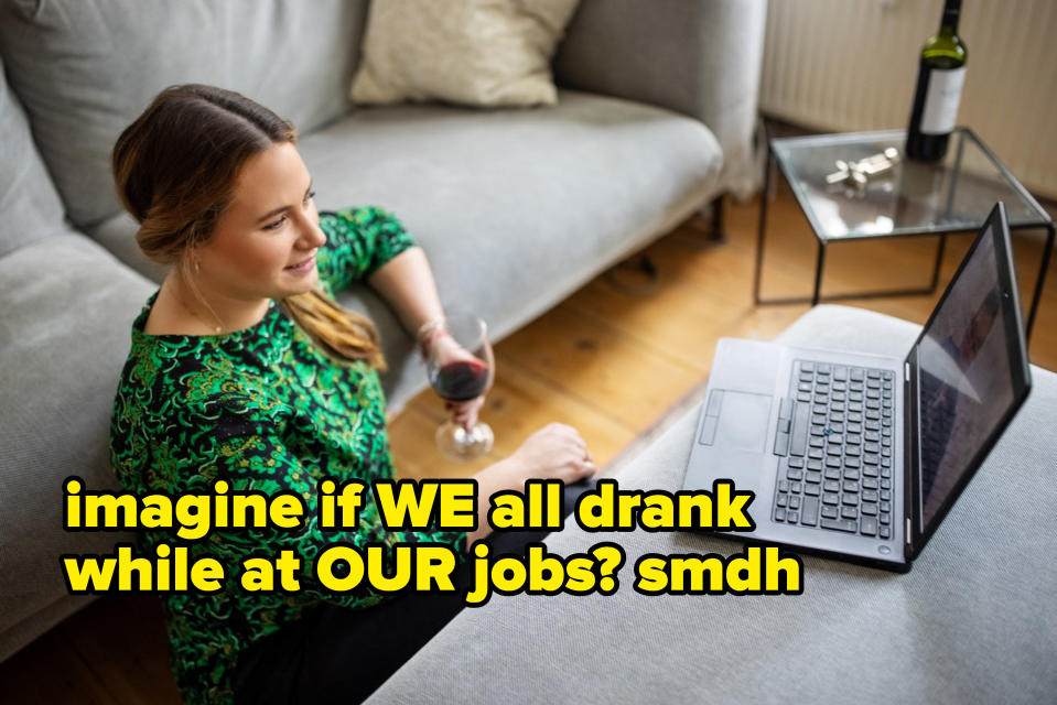 A woman drinking a glass of wine while on her laptop