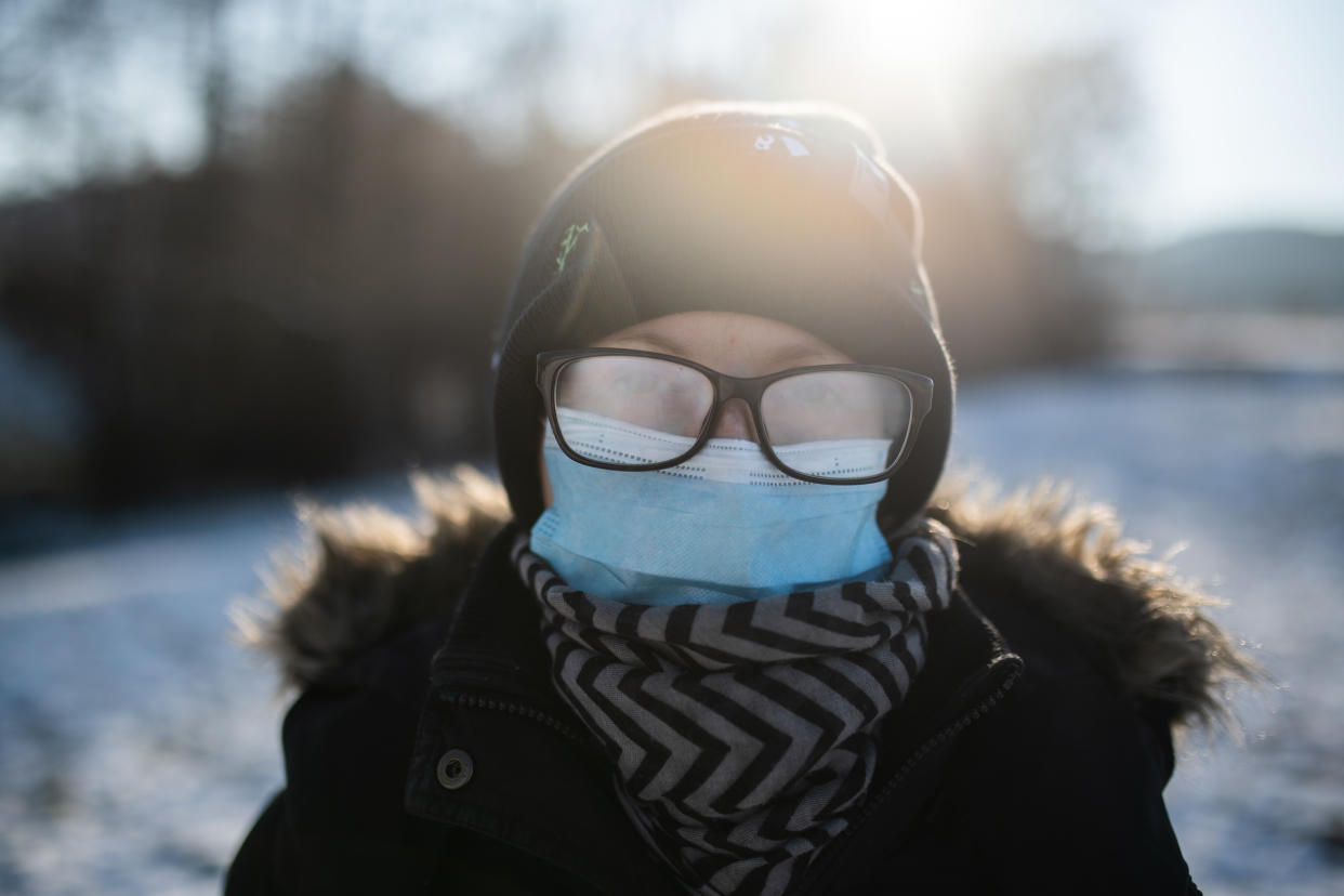 Woman with face mask and fogged up eyeglasses. 