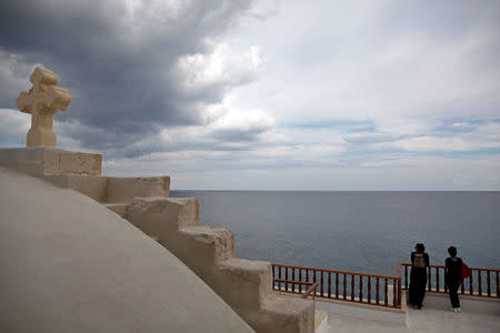 Pilgrims enjoy the view of the Monastery of Apostolos Andreas in north-eastern Cyprus after the structure was reopened after two years of renovation, Cyprus November 7, 2016. REUTERS/Yiannis Kourtoglou