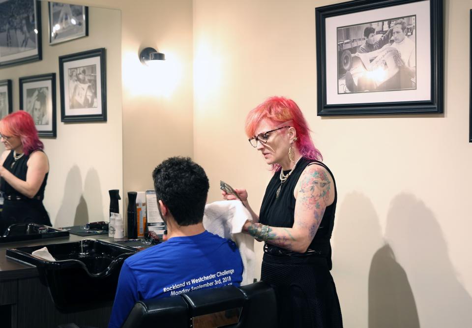 Danielle Braun works on a customer at The Fine Men's Salon of Westchester in Mamaroneck April 18,  2019.