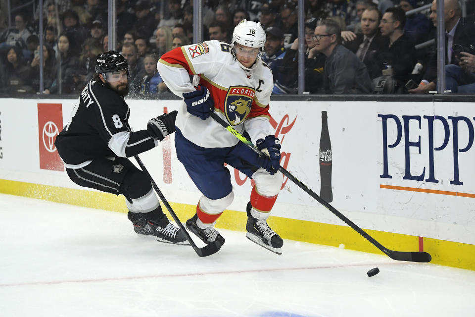 Florida Panthers center Aleksander Barkov, right, tries to pass the puck while under pressure from Los Angeles Kings defenseman Drew Doughty during the first period of an NHL hockey game Thursday, Feb. 20, 2020, in Los Angeles. (AP Photo/Mark J. Terrill)