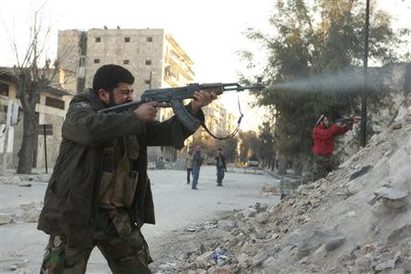 A Free Syrian Army fighter fires his weapon towards forces loyal to Syria's President Bashar al-Assad during clashes to take over Al-Milh square in Aleppo February 7, 2014. Picture taken February 7, 2014. REUTERS/Abdalrhman Ismail