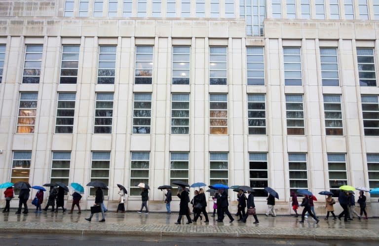 The prosecution team (center in black) walks past a line of people outside the Brooklyn federal courthouse before opening arguments in Guzman's trial on November 13, 2018