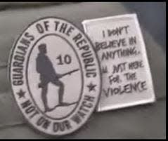 Patches that federal prosecutors say the militant Oath Keepers group wore as they assaulted the U.S. Capitol. One reads, "I don't believe in anything. I'm just here for the violence."