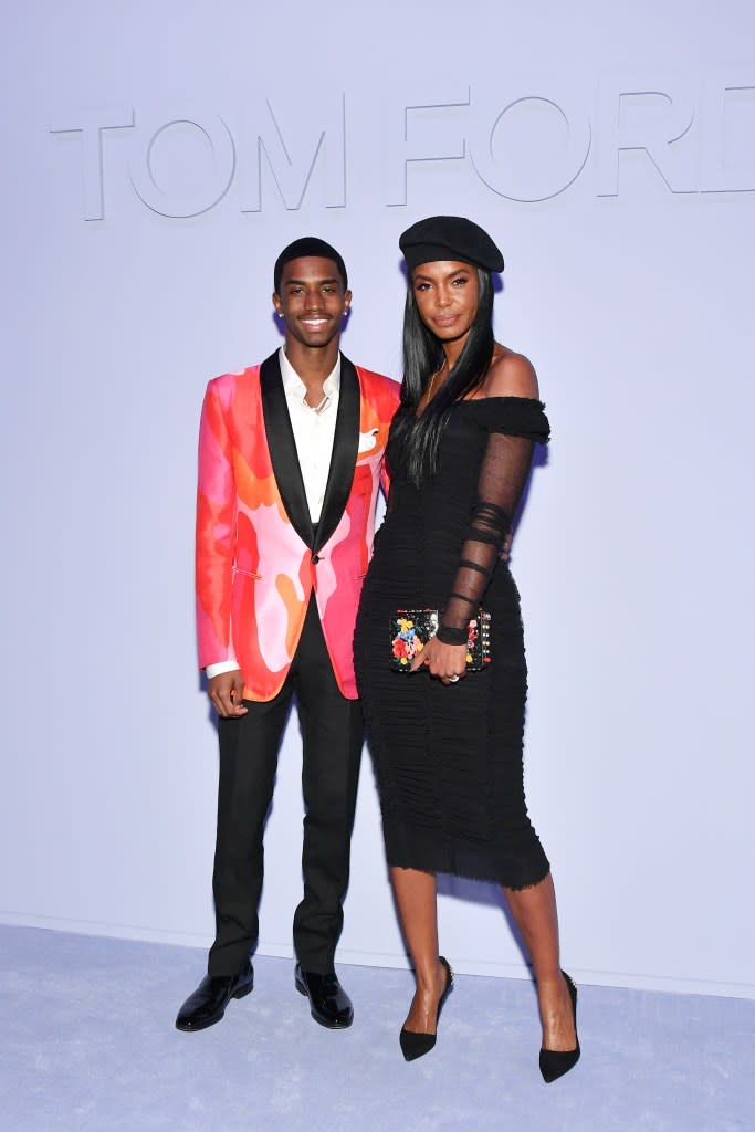 Christian Combs and his late mother, Kim Porter, at a fashion show in 2018. She died of pneumonia later that year. Getty Images