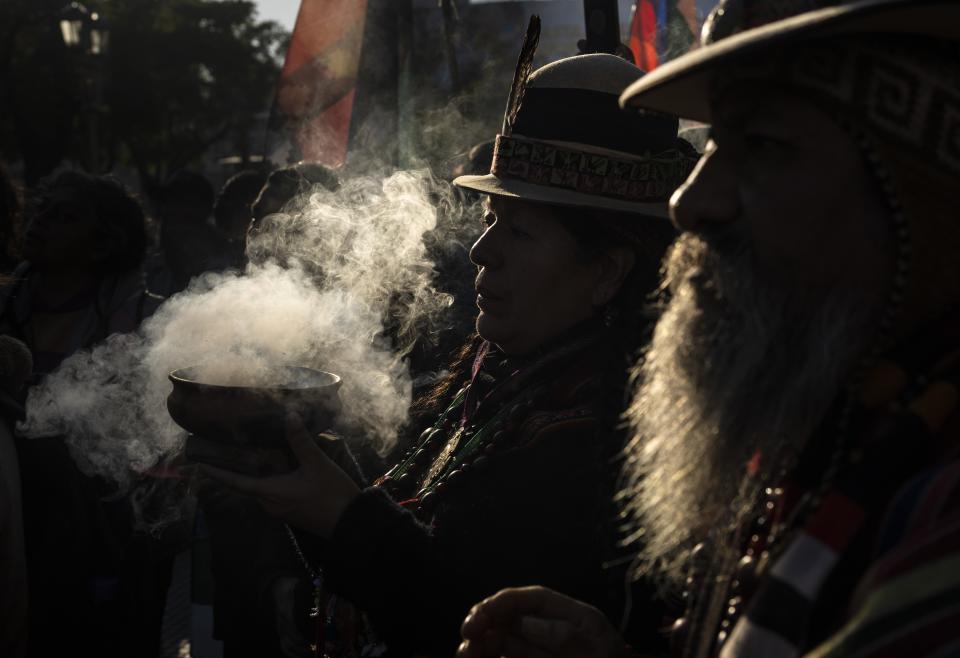 Indigenous leaders from the province of Jujuy burn incense during the celebrations of "La Pachamama," or Mother Earth Day in Buenos Aires, Argentina, Tuesday, Aug. 1, 2023. (AP Photo/Rodrigo Abd)