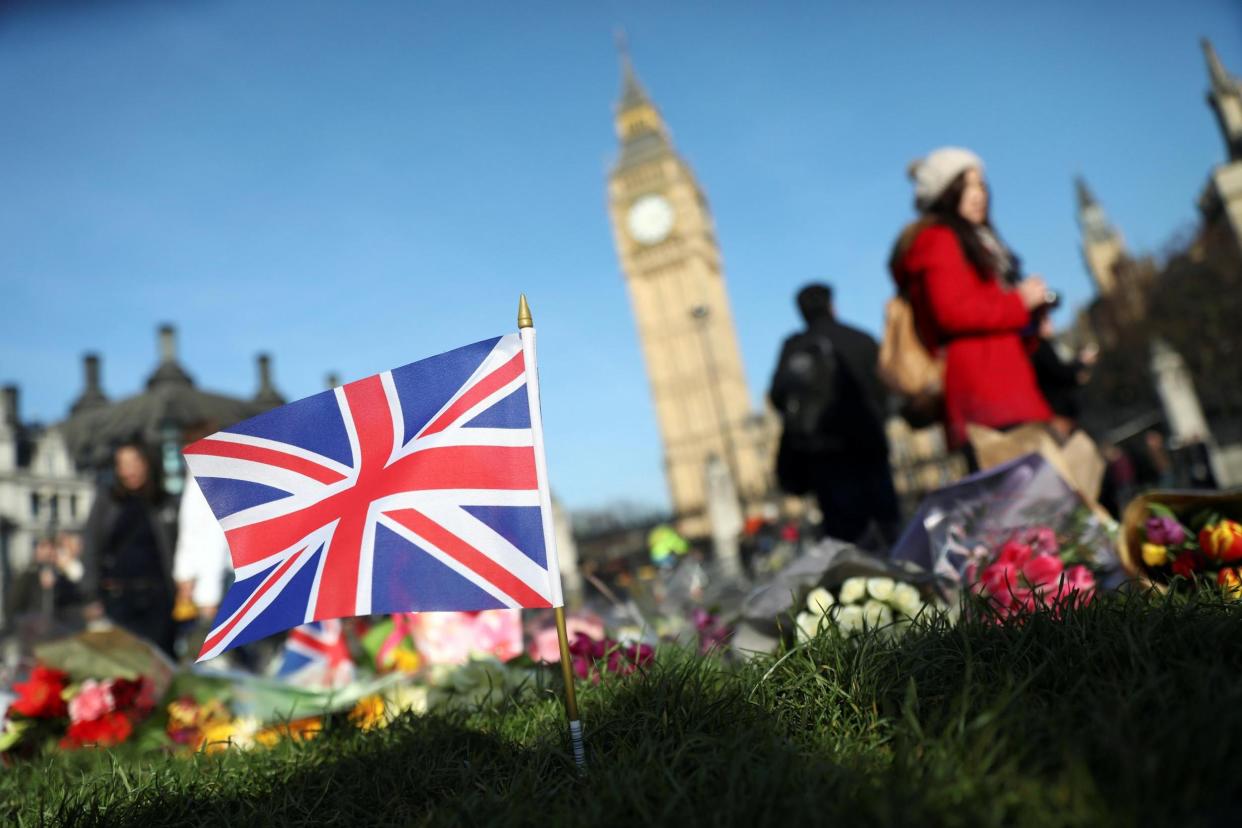 Poignant: Flowers were left at the scene in Westminster: REUTERS