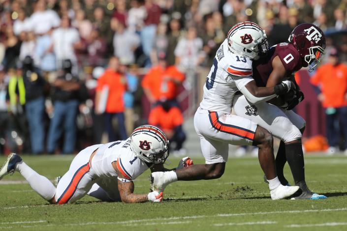 Nov 6, 2021; College Station, Texas, USA; Texas A&amp;M Aggies wide receiver Ainias Smith (0) is tackled by Auburn Tigers safety Ladarius Tennison (13) in the first quarter at Kyle Field.
