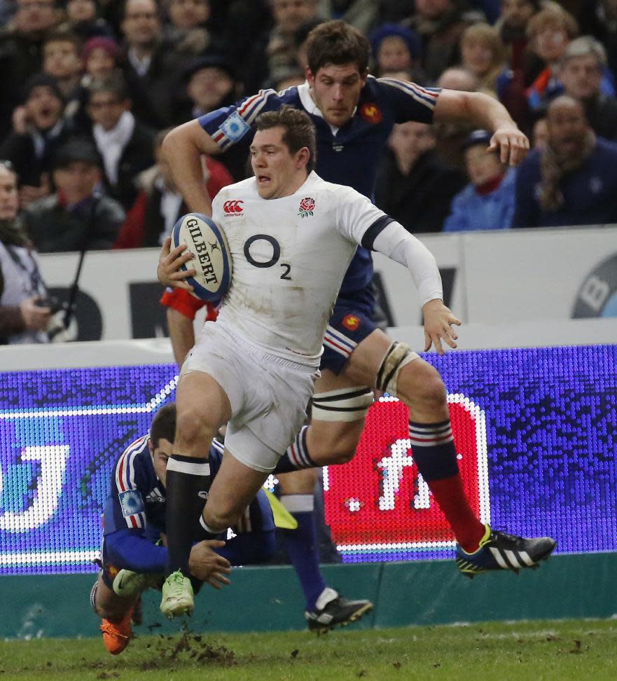 England's Alex Goode, center, is tackled by France's Pascale Pape, left, and Alexandre Flanquart during their Six Nations international rugby union match between France and England at Stade de France stadium in Saint Denis, near Paris, Saturday, Feb. 1, 2014. (AP Photo/Michel Euler)
