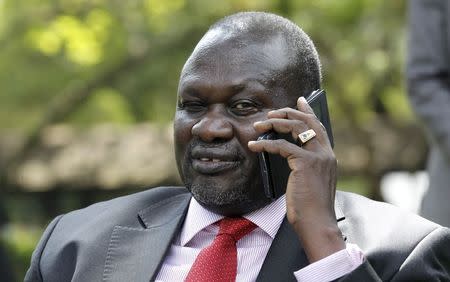 South Sudan's rebel leader Riek Machar speaks on a mobile phone after an interview with Reuters in Kenya's capital Nairobi July 8, 2015. REUTERS/Thomas Mukoya