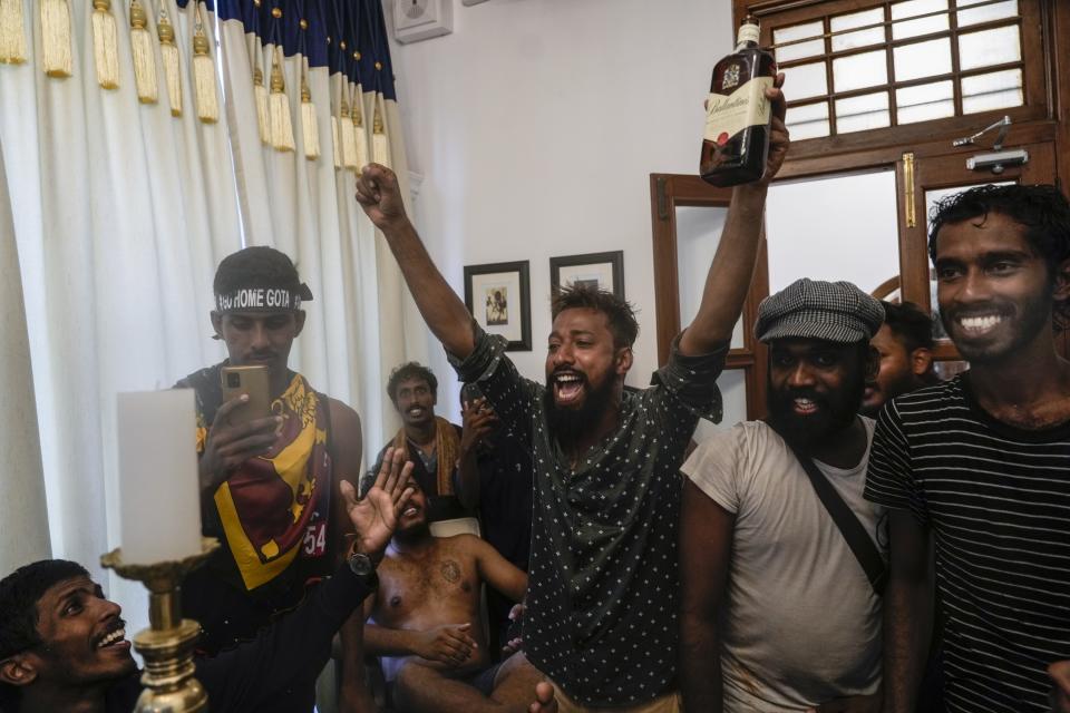 Protesters cheer after storming the Sri Lankan Prime Minister Ranil Wickremesinghe's office, demanding he resign after president Gotabaya Rajapaksa fled the country amid economic crisis in Colombo, Sri Lanka, July 13, 2022. The image was part of a series of images by Associated Press photographers that was a finalist for the 2023 Pulitzer Prize for Breaking News Photography. (AP Photo/Rafiq Maqbool)