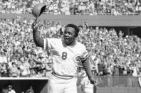 FILE - In this Saturday, Oct. 16, 1976, file photo, Cincinnati second baseman Joe Morgan tips his helmet to the fans as he rounds the bases after a homer in the first inning against the New York Yankees at Riverfront Stadium in Cincinnati. The affection drenches Clint Hurdle’s voice when he talks of them, when he appraises the list of those recently gone — childhood idols who became teammates and opponents, teammates and opponents who became acquaintances, acquaintances who became friends.(AP Photo/File)