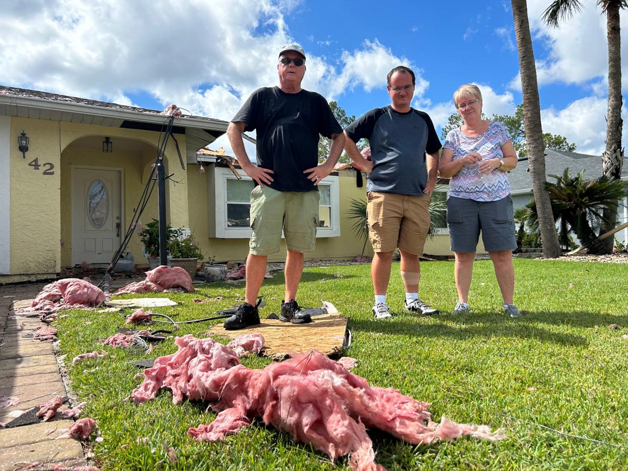 Brad and Susan Fallot and their son, William Fallot, in front of their home on Baltimore Lane in Palm Coast. A tornado wrecked the house on Thursday morning.