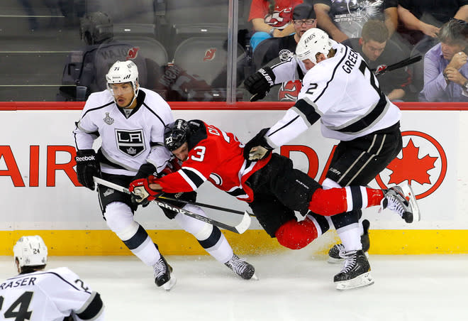  David Clarkson #23 Of The New Jersey Devils Draws Contact From Matt Greene #2 And Jordan Nolan #71 Of The Los Angeles  Getty Images