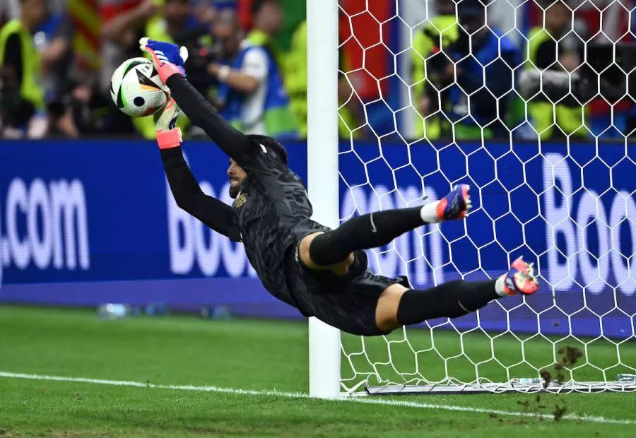 Diogo Costa saves a penalty for Portugal.