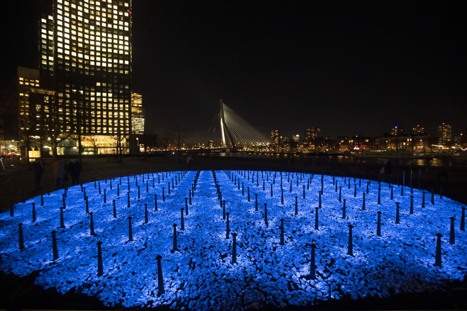 The monument Levenslicht, or Light of Life, by artist Daan Roosegaarde, consisting of 104,000 light-emitting stones for the number of Dutch Holocaust victims is unveiled in Rotterdam, Netherlands, Thursday, Jan. 16, 2020, to mark the 75th anniversary, later this month, of the liberation of Auschwitz concentration and extermination camp. (AP Photo/Peter Dejong)