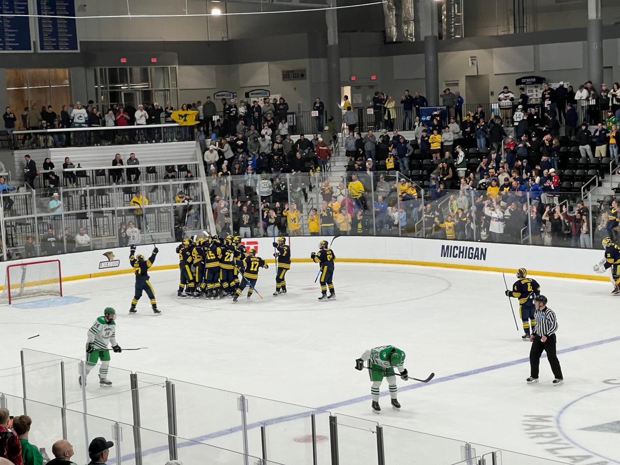 Michigan celebrates its 4-3 win over North Dakota on Friday night in the first round of the NCAA tournament in Maryland Heights, Missouri.