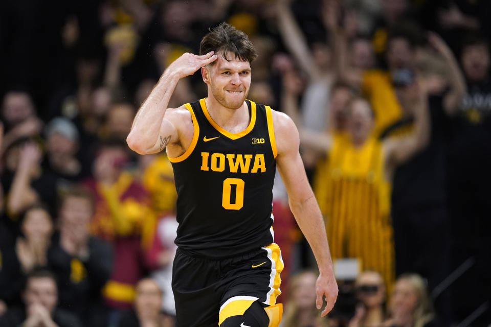 Iowa forward Filip Rebraca celebrates after making a 3-point basket during the first half of an NCAA college basketball game against Iowa State, Thursday, Dec. 8, 2022, in Iowa City, Iowa. (AP Photo/Charlie Neibergall)