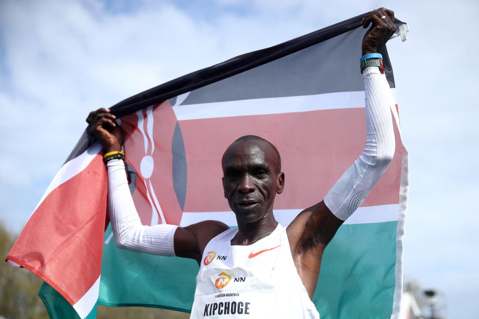 Eliud Kipchoge holds the Kenyan flag