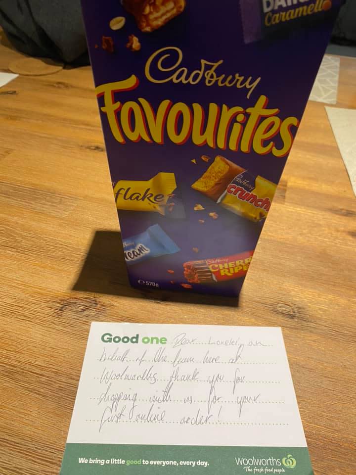 Pictured is a note from Woolworths supermarket alongside a box of Cadbury Favourites. 