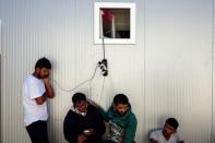 People charge their phones inside a camp for refugees and migrants in the town of Subotica, Serbia September 29, 2016. REUTERS/Marko Djurica