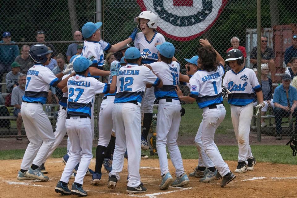 Toms River Carson Frazier is greeted at plate after hitting a three run homer. Toms River East defeats Hillsdale 8-4 in the 2021 NJ Little League State Tournament Championship game in Cherry Hill N.J. on August 1, 2021.