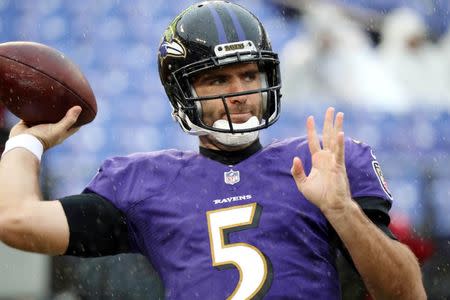 Dec 16, 2018; Baltimore, MD, USA; Baltimore Ravens quarterback Joe Flacco (5) warms up in the rain prior to his first career game as a backup against the Tampa Bay Buccaneers at M&T Bank Stadium. Mandatory Credit: Mitch Stringer-USA TODAY Sports