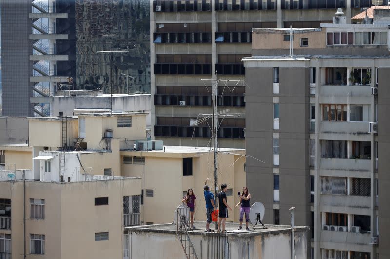 People gather at a rooftop in a residential building during the national quarantine in response to the spread of coronavirus disease (COVID-19) in Caracas