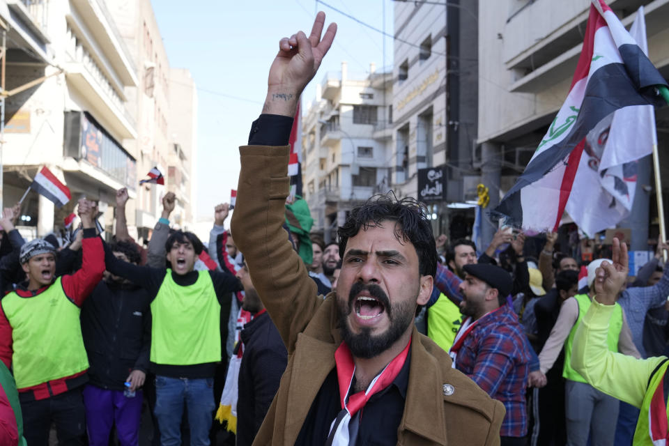 Demonstrators protest in front of the Iraqi central bank as currency plummets against the U.S. dollar, in Baghdad, Iraq, Wednesday, Jan. 25, 2023. (AP Photo/Hadi Mizban)