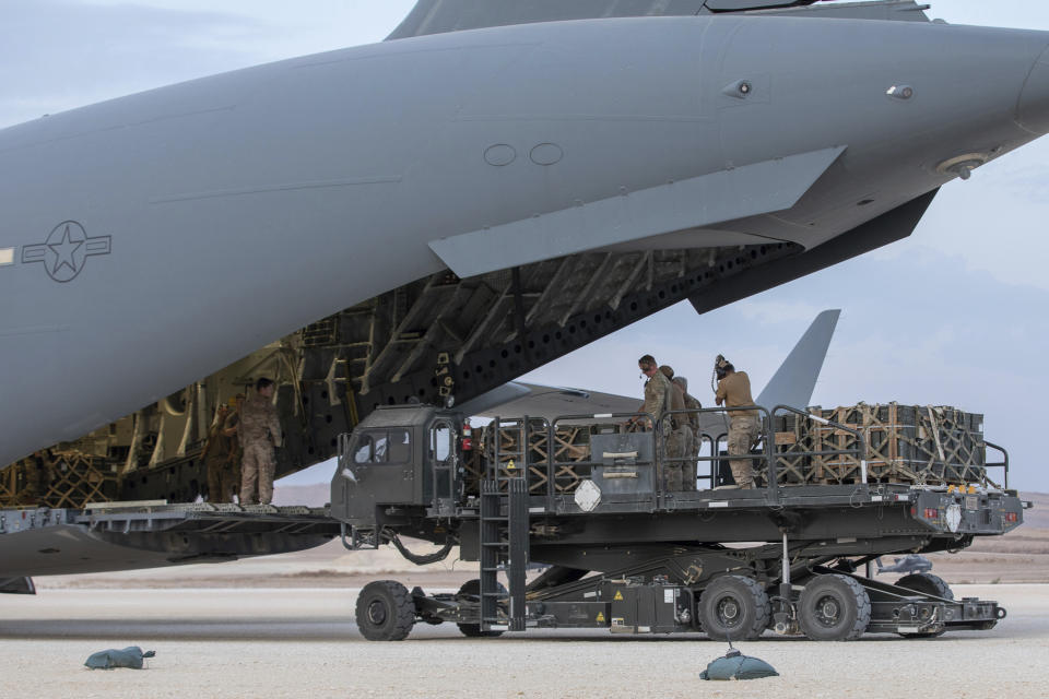 In this Oct. 24, 2019, photo, U.S. service members load military equipment from an aircraft cargo loader onto a plane at the Kobani Landing Zone (KLZ), Syria. Pivoting from the dramatic killing of the Islamic State group's leader, the Pentagon is increasing U.S. efforts to protect Syria's oil fields from the extremist group as well as from Syria itself and the country's Russian allies. It's a new high-stakes mission even as American troops are withdrawn from other parts of the country.(U.S. Army Reserve photo by Staff Sgt. Joshua Hammock via AP)