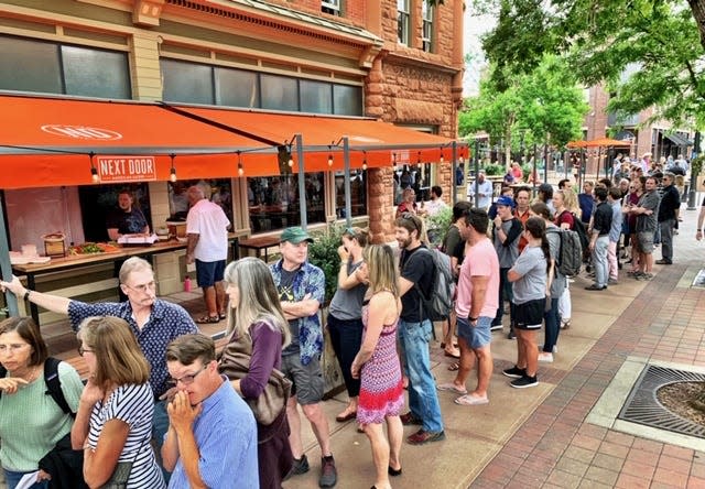 Crowds were out the door and well into Old Town Square waiting for the opening of Next Door American Eatery at the corner of College and Mountain avenues in Fort Collins in 2019.