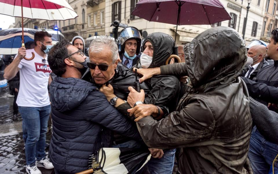 A demonstrator is arrested in Rome during protests against the economic situation in Italy during the lockdown exit strategy - Stefano Montesi - Corbis/Corbis News