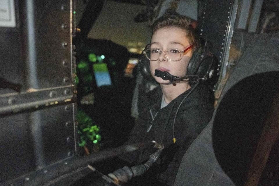 Released Israeli hostage Ohad Munder (9) sits inside an Israeli military helicopter, shortly after arrival in Israel on Friday, Nov. 24, 2023. A four-day cease-fire in the Israel-Hamas war began in Gaza on Friday with an exchange of hostages and prisoners. (IDF via AP)