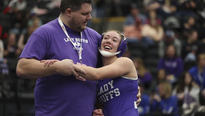 Tooele’s Anna Chlarson is congratulated by her coach Joel Spendlove after Chlarson beat Ridgeline’s Taya Crookston with a double chicken wing at the 4A State Championships at Utah Valley University in Orem on Wednesday, Feb. 14, 2024.