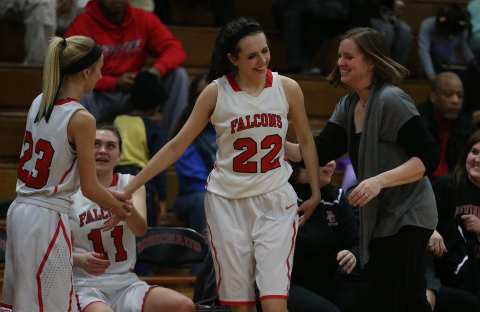 Mary Laney, right, played in the 1993 and 1994 state title teams for Dearborn Divine Child, and was the head coach for the Falcons' 2011 state championship.