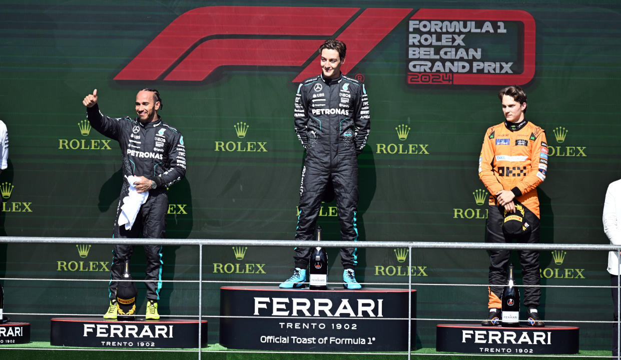 STAVELOT, BELGIUM - JULY 28: The British driver of the F1 Mercedes team George Russell in the first place, the British driver of the F1 Mercedes team Lewis Hamilton in the second place, and the Australian driver of the McLaren F1 team Oscar Piastri in the third place take the stage to receive their rewards on the winner's podium after the Formula 1 Belgian Grand Prix at the Spa Circuit in Francorchamps, Stavelot, Belgium on July 28, 2024. (Photo by Dursun Aydemir/Anadolu via Getty Images)