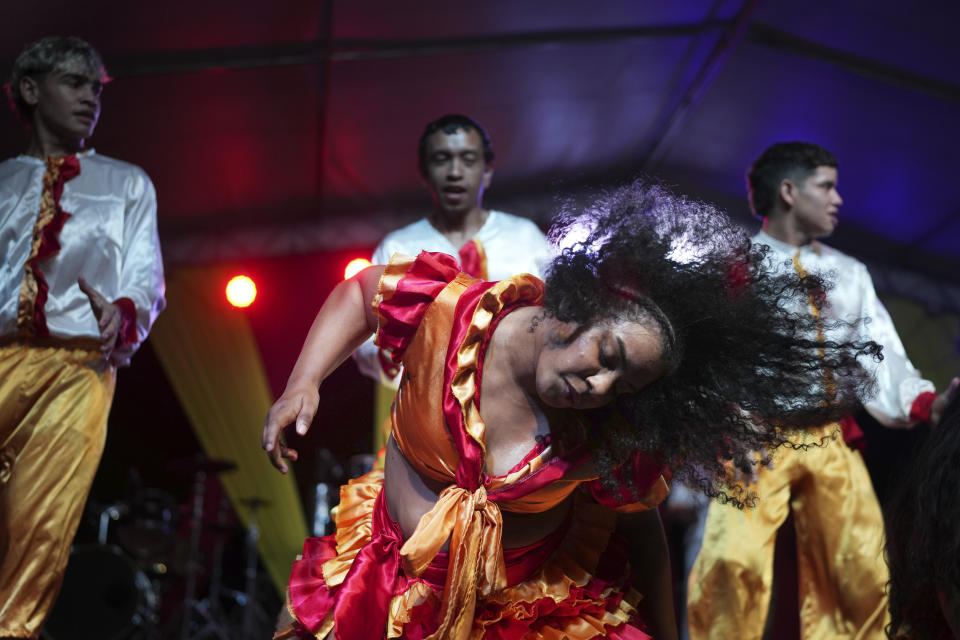 A member of the Paraguay-African cultural group Kamba Cua dances to honor Saint Balthazar, one of the Three Kings, as part of Epiphany celebrations in Fernando de la Mora, Paraguay, Saturday, Jan. 6, 2024. (AP Photo/Jorge Saenz)