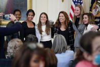 FILE - Briana Scurry, from left, former member of the U.S. Women's National Team, Margaret 'Midge' Purce, member of the U.S. Women's National Team, Kelley O'Hara, member of the U.S. Women's National Team, Julie Foudy, former member of the U.S. Women's National Team, and Cindy Parlow Cone, President of U.S. Soccer, pose for a photo with House Speaker Nancy Pelosi of Calif., before an event to celebrate Equal Pay Day and Women's History Month in the East Room of the White House, Tuesday, March 15, 2022, in Washington. The U.S. women's national team has not only been wildly successful on the field, the players have also been unabashedly outspoken, using their platform to advocate for equal rights for themselves and others. (AP Photo/Patrick Semansky, File)