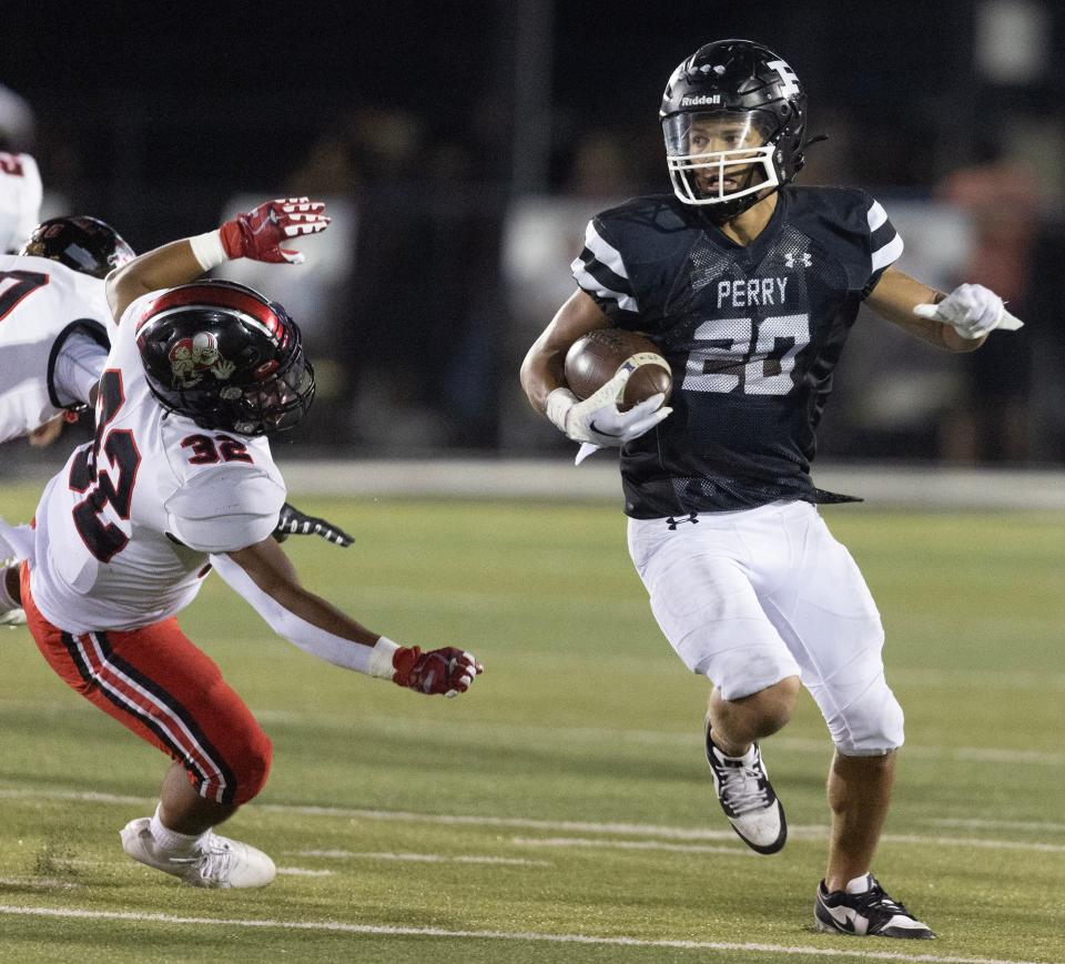 Perry's Christian Ivanic eludes the tackle of McKinley's Detryk Daniels in the second half Friday, September 8, 2023.