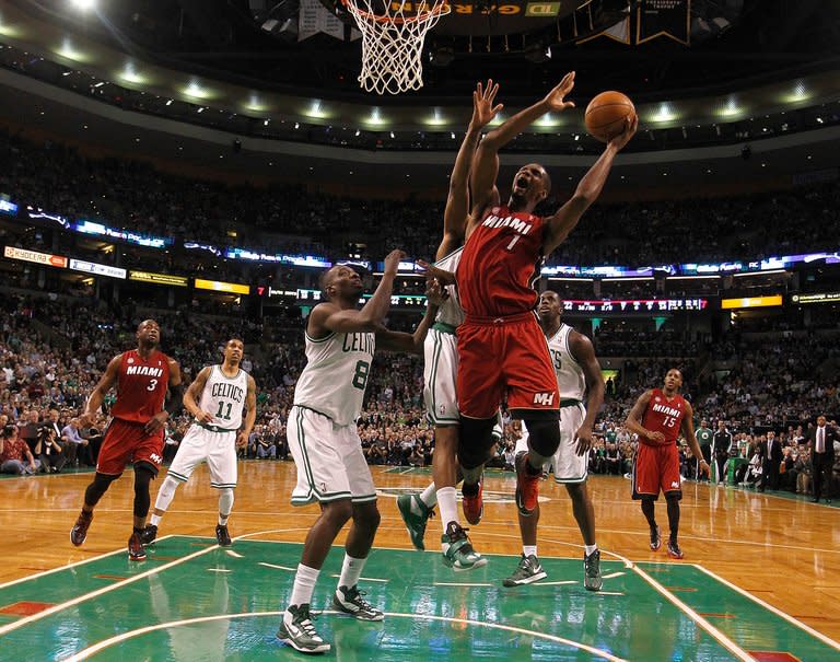 Chris Bosh of the Miami Heat beats Jeff Green of the Boston Celtics to the basket in the first half on March 18, 2013. A 105-103 win for Miami snapped an 11-game home win streak for the Celtics