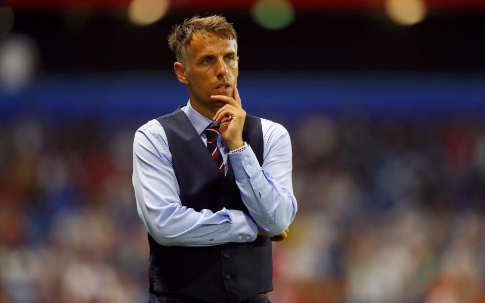 Phil Neville has followed Gareth Southgate in making the waistcoat a trademark of his success - FIFA