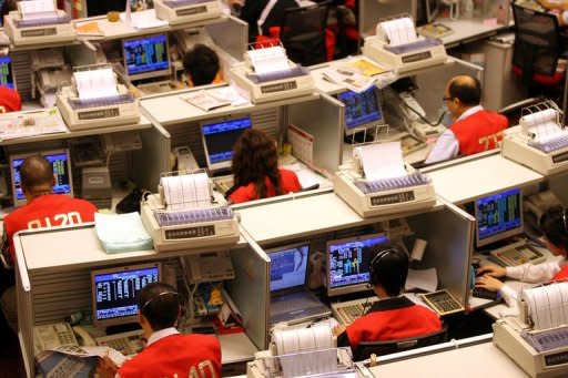 Traders are seen here on the floor of the Hong Kong Stock Exchange. The share price of Chinese online shopping portal Alibaba.com soared in HK on Wednesday after its parent company said it plans to take the company private for $2.3 billion