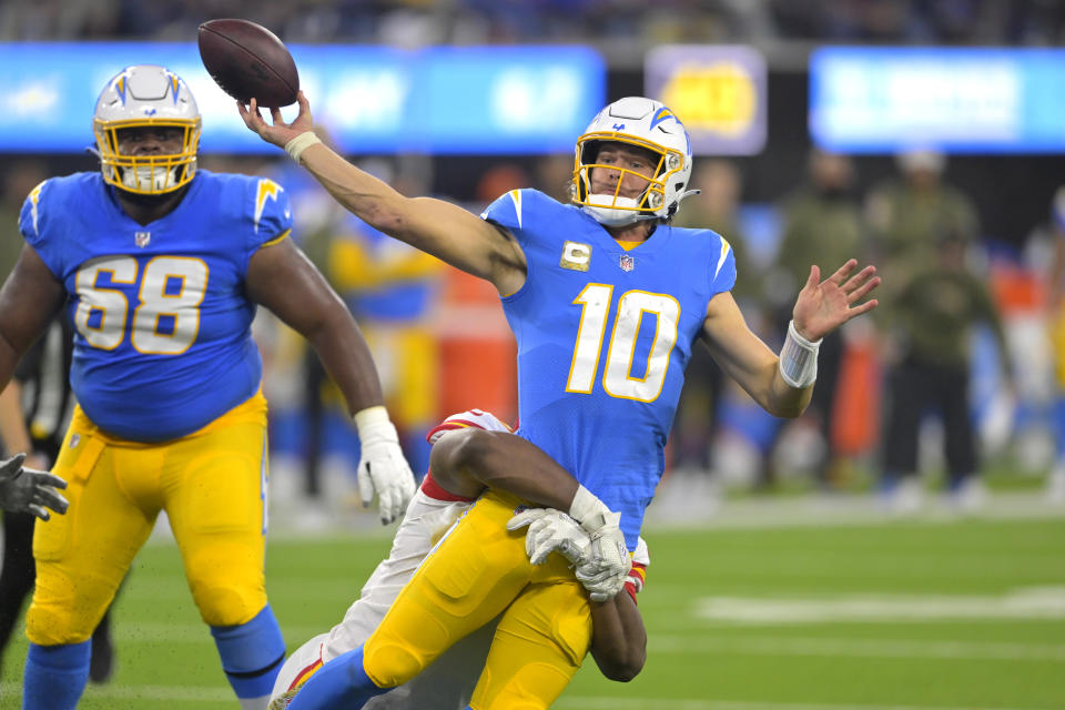 Los Angeles Chargers quarterback Justin Herbert, right, throws for an incomplete pass as Kansas City Chiefs defensive tackle Chris Jones tackles him during the first half of an NFL football game Sunday, Nov. 20, 2022, in Inglewood, Calif. (AP Photo/Jayne Kamin-Oncea)